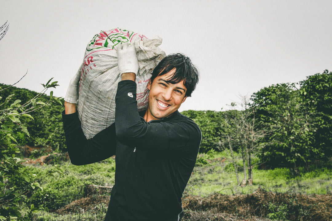 Augusto carrying coffee - Nossa Familia family farm